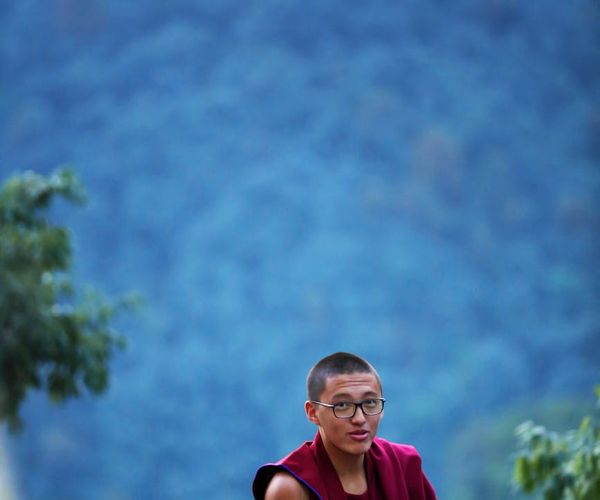 Person's focused face during a mindful movement practice, eyes closed in concentration.